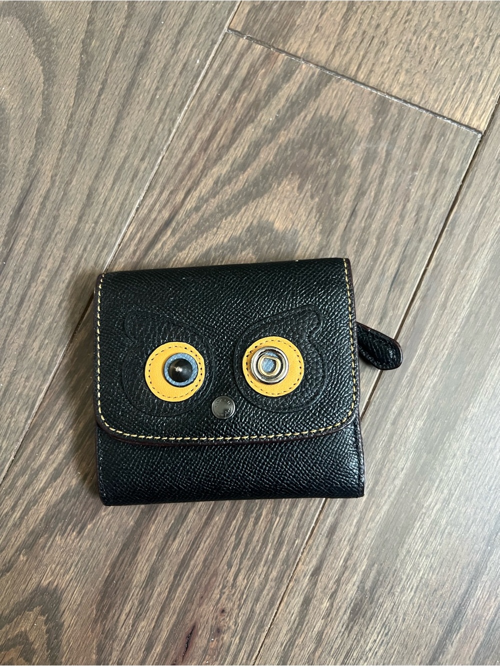 Coach Black Leather Compact Wallet with Yellow Eye Accents
